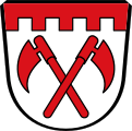 Gemeinde Horgauergreut In Silber zwei gekreuzte rot Reuthauen; im Schildhaupt ein silberner Zinnenbalken.