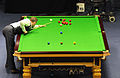 Mark Selby en position de jeu : jambe droite tendue, dos plat et chevalet solide.