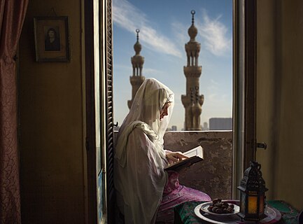 A woman in Egypt is inside her house practicing her rituals of worship during the month of Ramadan.