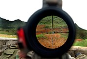 Looking through a US Army M24 sniper rifle scope at a practice range Camp Hansen