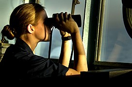 US Navy 030316-N-3783H-709 U.S. Navy Ensign Katharine Poole watches through binoculars for any surface contacts from the bridge aboard the guided missile cruiser USS Shiloh (CG 67).jpg