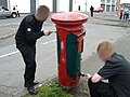 Irish Republicans painting a Royal Mail postbox in Derry for the Green Post-Box Campaign in 2008