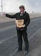 Patrick Falterman hitchhiking with a cardboard sign near Calama, Chile.jpg