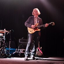 Buck holding his guitar