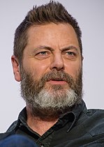 47-year-old man with brown hair and a greying beard talking to the right