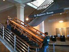 Two students carry the bench up the stairs to the Great Hall (3644fec9-155d-451f-6706-318a4a3f4d7e).JPG