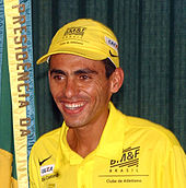 A photo of Marílson Gomes dos Santos wearing a yellow top and cap