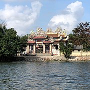 Tam quan of a temple next to the river