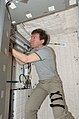 Michael Barratt works inside a newly installed crew quarters compartment