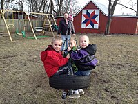 Children on a tire swing