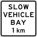 (A42-4/IG-9) Slow Vehicle Bay Ahead (in 1 kilometre)