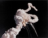 Space Shuttle Challenger explodes shortly after take-off.