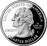 Shiny silver coin with profile of Washington bust. He faces left regally and wears a colonial-style queue in his hair. "UNITED STATES OF AMERICA" is at top, "QUARTER DOLLAR" at bottom, "LIBERTY" at left, and "IN GOD WE TRUST" above "S" at right. Just below the bust is "JF uc" in tiny letters.