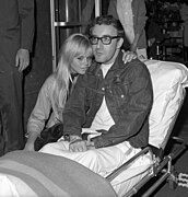 Peter Sellers sitting up in ambulance gurney with wife Britt Eklund.jpg