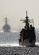 US Navy 050210-N-0499M-025 The guided missile cruiser USS Shiloh (CG 67) cruises forward as the guided missile destroyer USS Benfold (DDG 65) follows in the rear while underway in the Pacific Ocean.jpg