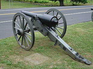 Photo shows a 20-pounder Parrott rifle with a highway a short distance beyond it.