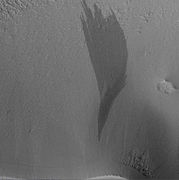 G. Shallow avalanche scars associated with dark slope streak. The slope streak has the same sharp apex and triangular-faceted morphology as the scars, suggesting that both types of features have a similar origin. Image is from HiRISE.