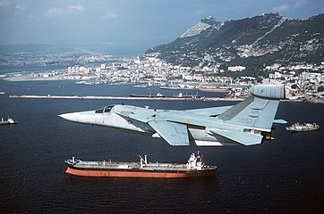 An EF-111A Raven aircraft flying past the Rock of Gibraltar