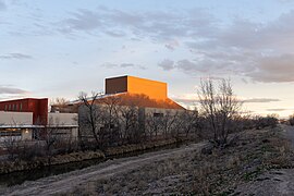 The sunset illuminates the top of the Roy E. Disney Center for Performing Art building at the National Hispanic Cultural Center in Albuquerque, New Mexico.jpg