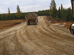 Caterpillar D300E hauling on a corduroy road built over muskeg