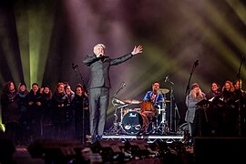 Dunstan Bruce from Chumbawamba, the Opera North chorus and Hope & Social on stage at the Awakening. LEEDS 2023.jpg