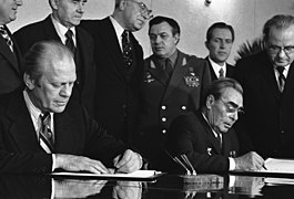 Photograph of President Gerald Ford and Soviet General Secretary Leonid Brezhnev Signing a Joint Communique on the Limitation of Strategic Offensive Arms following their Bilateral Talks in the Conference Hall of t(...) - NARA - 7162417.jpg