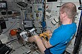 Frank De Winne performs activation and checkout steps on the new ESA Flywheel Exercise Device (FWED), with the Internal Wireless Instrumentation System (IWIS) accelerometer