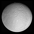 Image 7 Rhea Photo credit: Cassini orbiter Rhea, at 1,528 kilometres (949 mi) across, is the second-largest moon of Saturn and the ninth largest moon in the Solar System. It was discovered in 1672 by Giovanni Domenico Cassini, who named it after the Titan Rhea of Greek mythology, "mother of the gods". The giant Tirawa impact basin is seen above and to the right of center. Tirawa, and another basin to its southwest, are both covered in impact craters, indicating they are quite ancient. More selected pictures