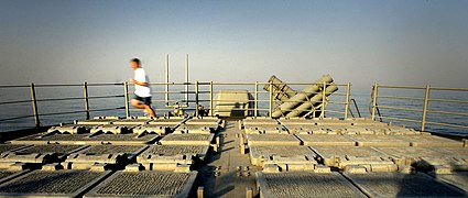 US Navy 030317-N-3783H-147 Crewmembers aboard USS Shiloh (CG 67) jog, run, and conduct physical training (PT) in the area of the missile decks aboard the guided missile cruiser.jpg