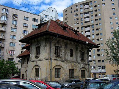 Old house surrounded by apartment blocks