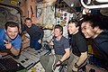 Expedition 20 crew members view a monitor as they celebrate Father's Day and the birthday of cosmonaut Gennady Padalka (center)