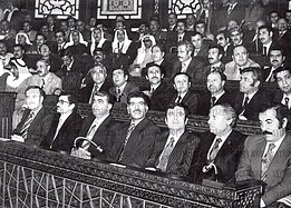 Large group of men sitting in rows