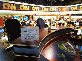 The newsroom of the Cable News Network (CNN). The combination of hundreds of cable television channels and 24-hour news services like CNN give an unprecedented impact and immediacy to news developments around the world.