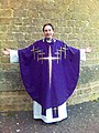 Sacerdote anglicano en ornamentos eucarísticos: alba, casulla y estola moradas.