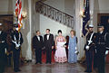 President Richard Nixon and Mrs. Nixon and President Josip Broz Tito and Mrs. Broz, in black tie, enroute to a dinner in President Tito's honor, 1971