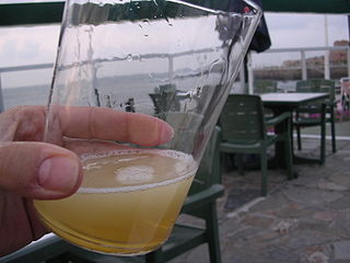 Glass of cider just poured (Asturias, Spain)