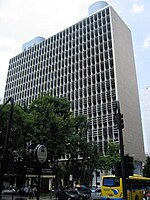 A modernist high building with water tanks on the top