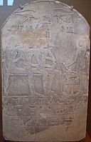 A funerary stela of a man named Ba (seated, sniffing a sacred lotus while receiving libations); Ba's son Mes and wife Iny are also seated. The identity of the libation bearer is unspecified. The stela is dated to the Eighteenth dynasty of the New Kingdom period.]]
