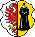 Gemeinde Münchsteinach Gespalten von Silber und Gold; vorne am Spalt ein halber, gold bewehrter roter Adler mit goldenem Kleeblattbogen auf dem Flügel, hinten ein stehender schwarz gekleideter Benediktinermönch.