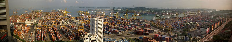 The Port with a large number of shipping containers and the ocean visible in the background