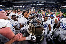 Air Force celebrates with the Commander-in-Chief's trophy.jpg