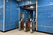 Stairs from the middle platform to the concourse, with separate turnstiles for passengers to exit the station