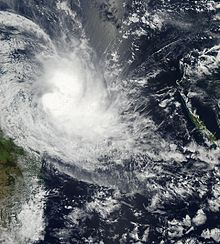A satellite image of a developing tropical cyclone. Rainbands can be seen swirling into the cyclone