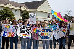 Students holding protest signs during a May 2023 Policy 713 rally in Quispamsis