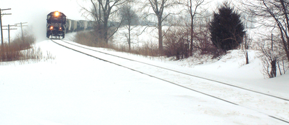 Freight train on snow-covered tracks in rural Indiana, Rail transport