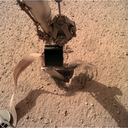 Insight lander using its scoop to push on the back cap of the HP3 mole.