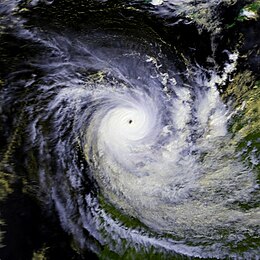 Satellite image of a powerful cyclone near the coast of Western Australia. The storm is very mature, with a large area of deep thunderstorms and a well-defined, clear eye.