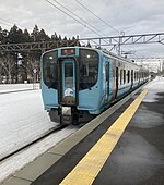 Aoimori 703 series two-car electric multiple unit (EMU) arriving at a train station