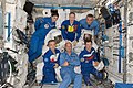 Expedition 21 crew members pose for a photo with three Extravehicular Mobility Unit (EMU) spacesuits