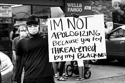 Protestor with sign, Minneapolis, May 26